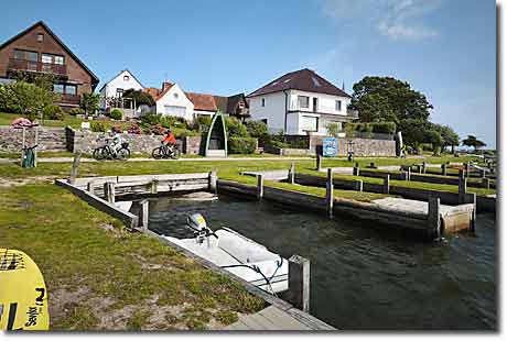 Maasholm: Rundweg an der Schlei Zwei Radfahrer auf dem Rundweg in Maasholm vorbei an historischen Kahnstellen und Häusern direkt an der Schlei